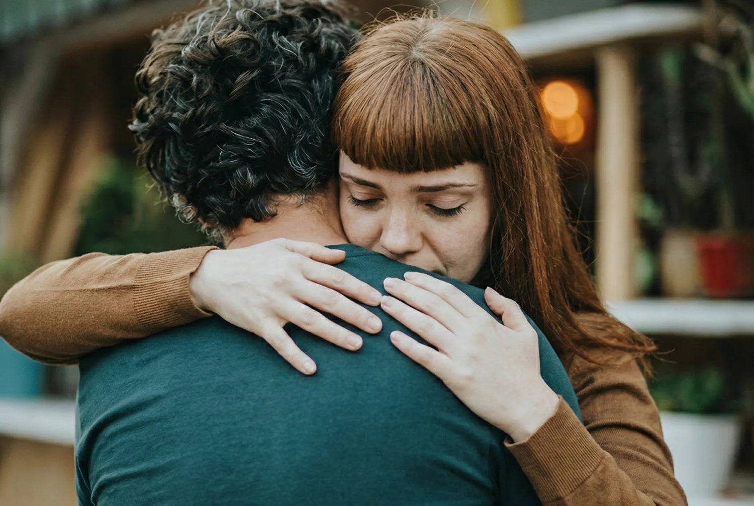 Couple hugging in remembrance after being given a gift