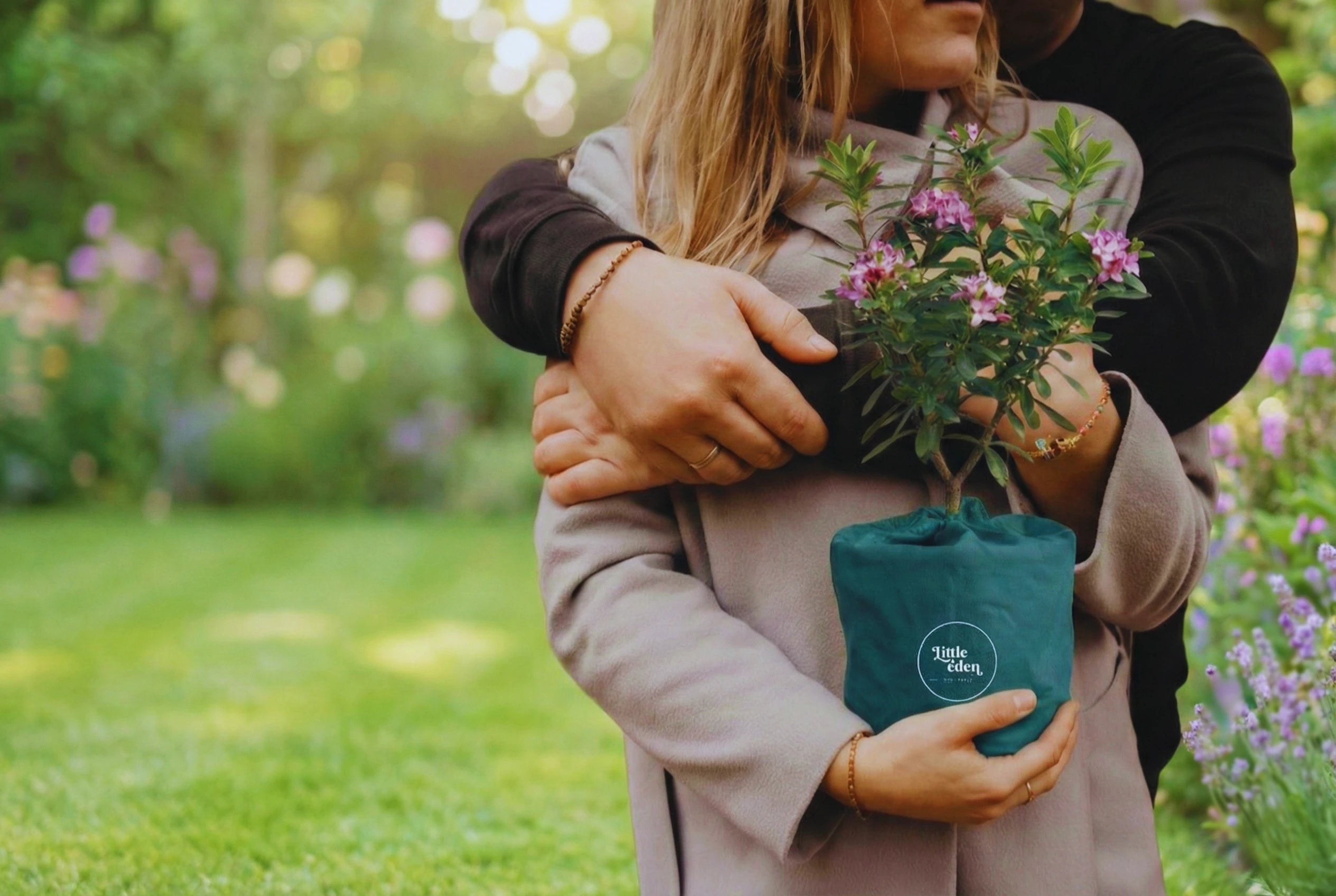 A supportive bereavement gift: A couple holding a flowering memorial shrub in Little Eden branded packaging